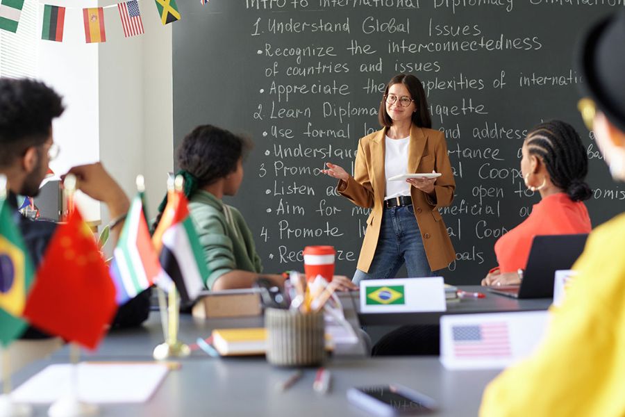 Female teacher facing classroom of high school students